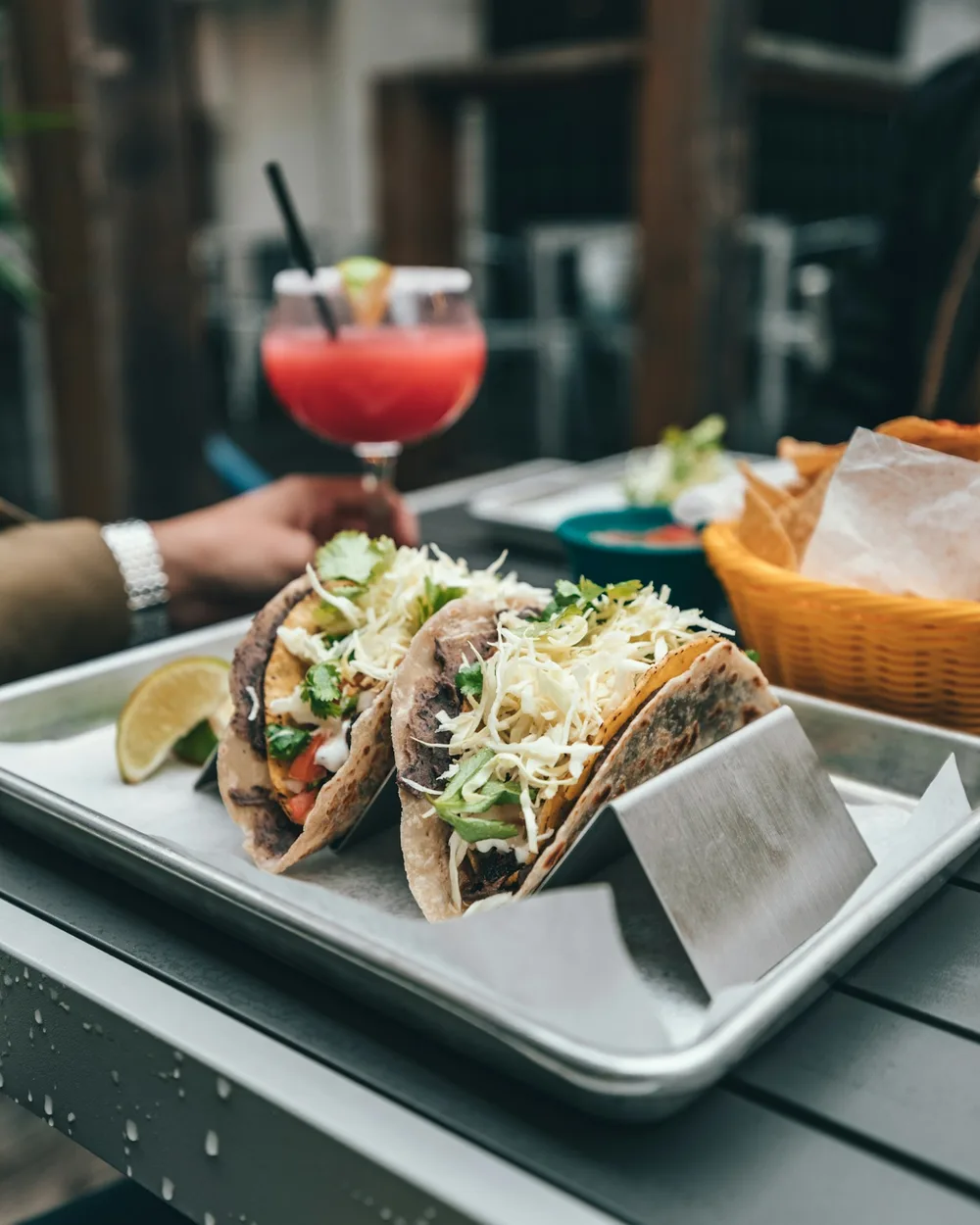 Tacos topped with cabbage and fresh herbs